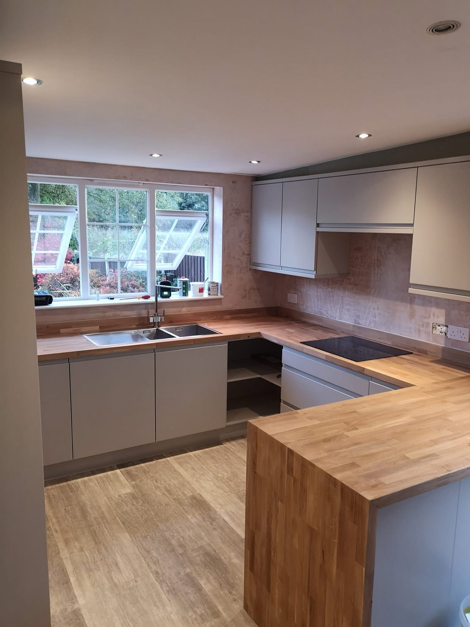 Completed bespoke kitchen with solid oak worktops and handleless cabinetry