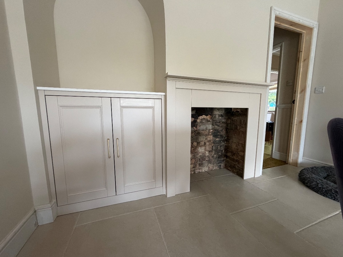 Bespoke alcove unit, with matching fire surround. — Living room by R. Plane Carpenter, Norwich.